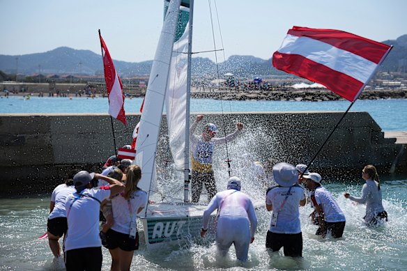 Lukas Maehr of Austria (back, centre), celebrates after winning gold in the 470 mixed dinghy medal race. 