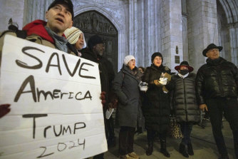 Supporters of former US president Donald Trump sing the national anthem during a “Justice for January 6th Vigil” at St. Patrick’s Cathedral in New York last week.