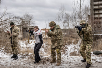 Civilian Ukrainians have been called up for combat training using toy weapons in case Russian troops invade. 