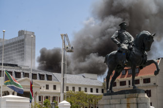 Firemen spray water on flames erupting from a building at South Africa’s Parliament in Cape Town.
