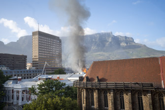 Flames erupt from a building at South Africa’s Parliament in Cape Town on Sunday.