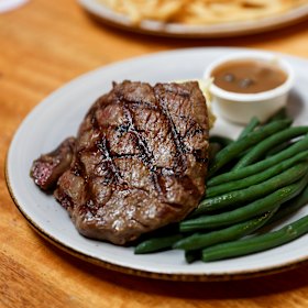 Homesick for a steak and beer on tap: Byak’s 250g rump steak with mash, mushroom sauce and green beans. 