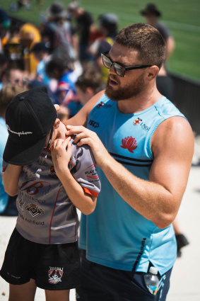 NSW No.6 Lachie Swinton signs autographs at the team’s trial against Shute Shield clubs on the weekend.
