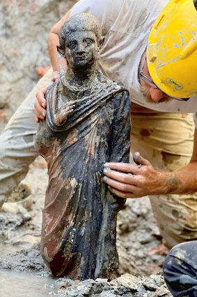 Archaeologists work at the site of the discovery.