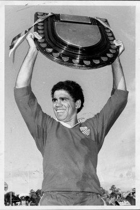 Mark Ella proudly displays the Shute Shield at the end of the grand final in 1984.