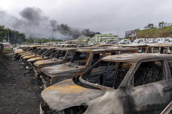 Burnt cars are lined up after unrest that erupted following protests over voting reforms in Noumea, New Caledonia.