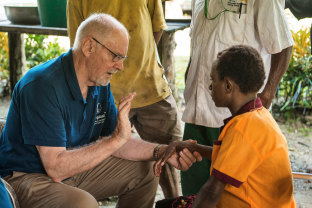 Dr Russell Corlett, left, with a patient in Papua New Guinea in 2016.