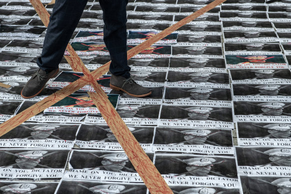 Posters bearing the face of Myanmar military chief Min Aung Hlaing during a demonstration in Tokyo on Monday against the military coup in Myanmar.