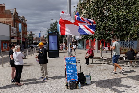 Independent candidate Joseph 77 speaks with members of the public in Clacton-on-Sea’s town square.