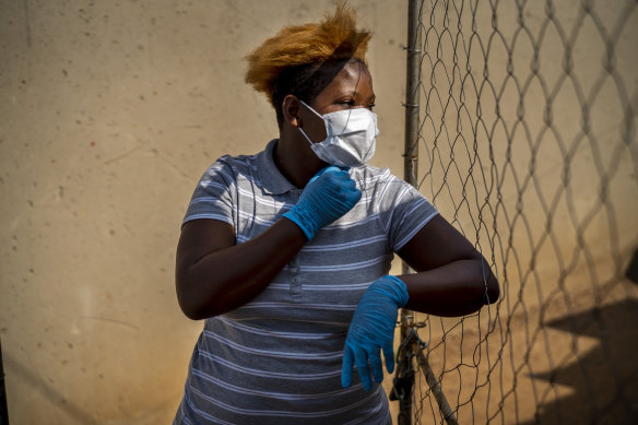 Mabatho Mphuthi is one of the very few people wearing a mask in response to the COVID-19 virus outbreak in the Diepsloot township north of Johannesburg, South Africa, on Saturday.