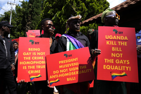 Activists hold placards during their picket against Uganda’s anti-homosexuality bill at the Ugandan High Commission in Pretoria, South Africa.