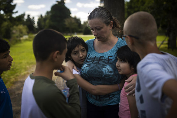 Olga Lopatkina embraces her adopted children in a park in Loue, western France in July. 