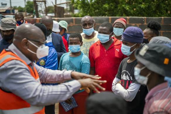 Residents listen to Gauteng Province Premier David Makhura in Lawley, South Africa, during a vaccination drive.