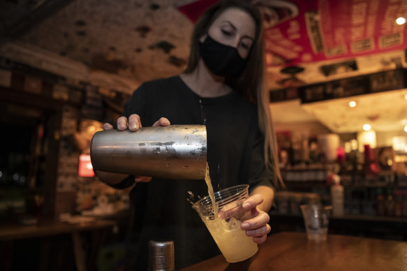 Bartender Veronica Simard, from Bondi Tony’s Burger Joint, pours a takeaway margarita for a customer 