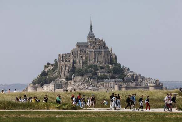 People walk around Le Mont-Saint-Michel in north-western France.
