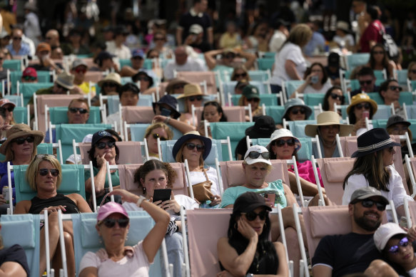 Spectators watch from deck chairs in Garden Square on Saturday.