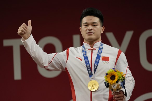 Shi Zhiyong of China celebrates his gold in the men’s 73kg weightlifting in Tokyo.
