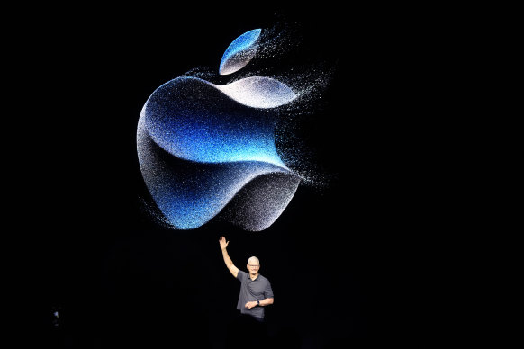Apple CEO Tim Cook waves as he walks to the stage during an announcement of new products.