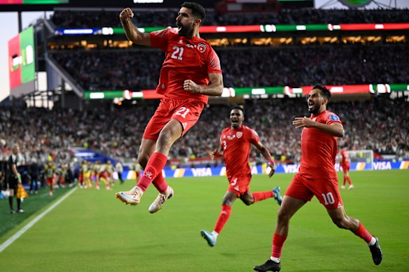 Jordan’s Nizar Al-Rashdan (left) celebrates after scoring the opening goal against Algeria. 