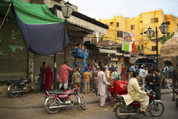 A street scene outside the Wazir Khan, built in the 17th century as a bathing temple.