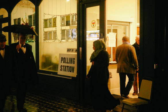 Wet, dark, and dutybound. Locals vote in London's Marchmont Community Centre in WC1.