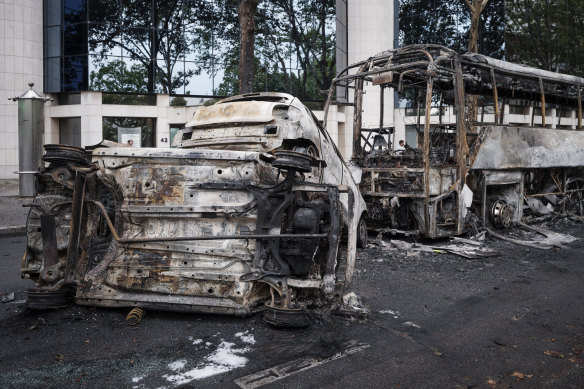 Charred cars and a bus are pictured in Lyon on Friday.