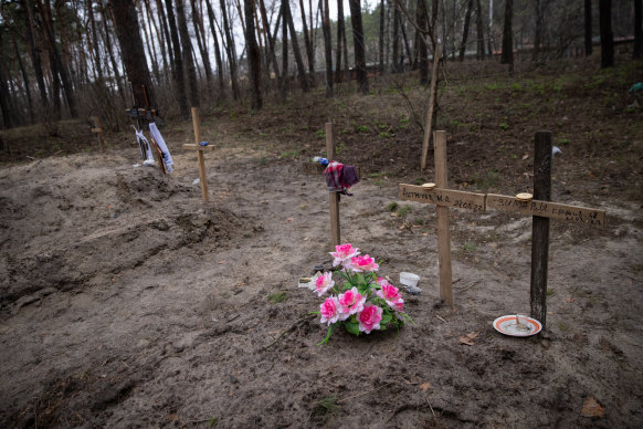 In a residential area in Trostyanets, Ukraine, sit makeshift graves of three civilians killed by Russian forces during the town’s occupation.