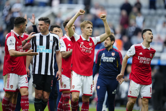 Arsenal’s Martin Odegaard, centre, and Gabriel Martinelli, right, celebrate after defeating Newcastle 2-0.