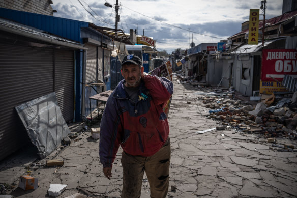 A man salvages goods from his shop after a Russian missile strike in the Kharkiv region.