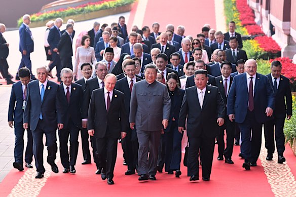 Chinese President Xi Jinping (centre) with Vladimir Putin, Kim Jong-un and other world leaders in Beijing on Tuesday.