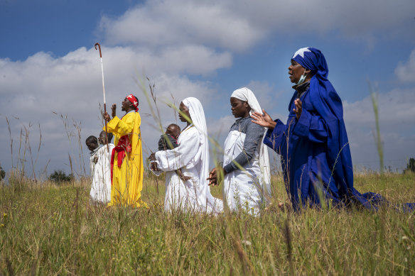 A handful of Pentecostals celebrate Easter in a field in Soweto, Johannesburg, April 4, 2021.