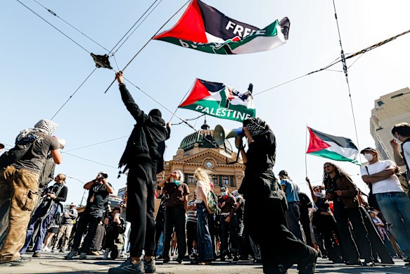 Protesters prepare to march from Flinders Street Station. 