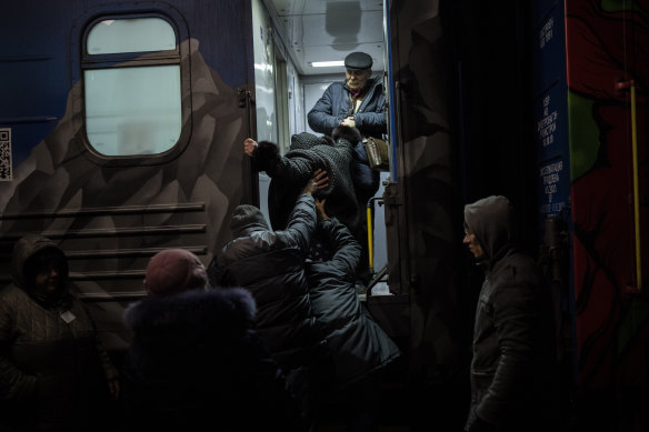 Ukrainians board the Kherson-Kyiv train at the Kherson railway station, southern Ukraine, fearing that a lack of heat, power and water due to Russian shelling will make conditions too unlivable this winter. 