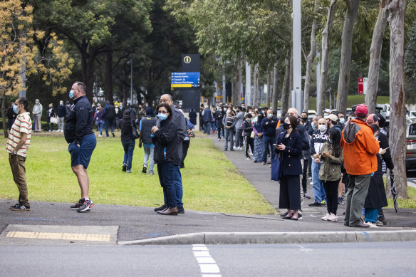 People wait for their allocated time slot earlier this month at the NSW vaccination hub in Homebush.
