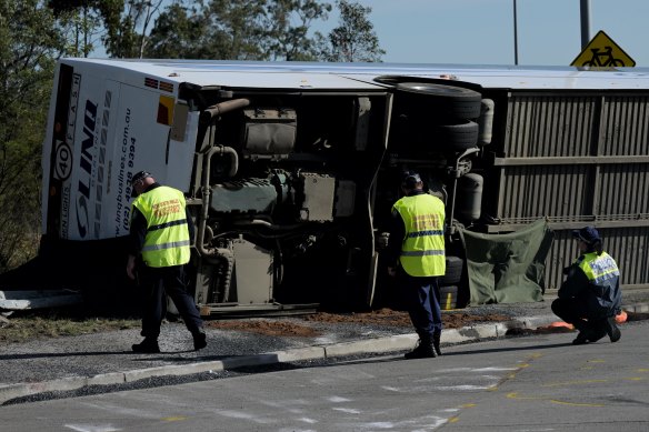 Police inspect the bus at the crash scene in the Hunter Valley last June.