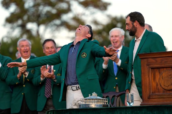 Scottie Scheffler puts the green jacket on winner, Rory McIlroy.