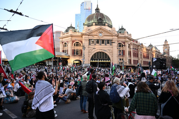 People block the Flinders Street intersection during a pro-Palestinian protest on Thursday afternoon.