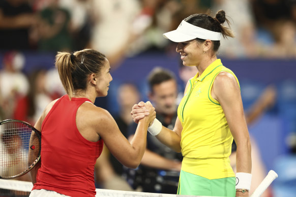 Ajla Tomljanovic (right) shakes hands at the net after defeating Natalija Stevanovic of Serbia.