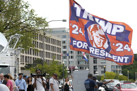 A Trump supporter waves a flag near the Federal Courthouse in Washington.