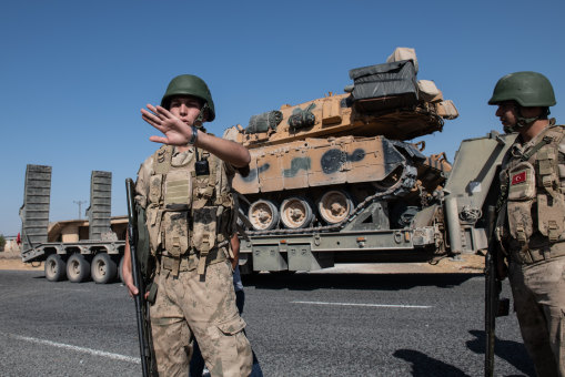 Offensive rolls on. Turkish military vehicles carry tanks to the Syrian border  at the weekend.