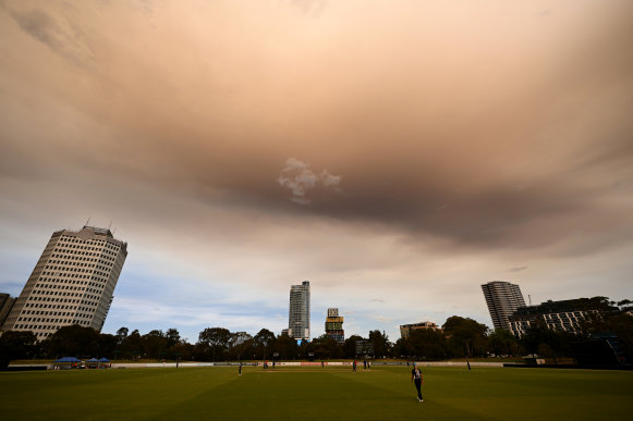 Smoke from a bushfire passes over the Junction Oval in Melbourne on Friday.
