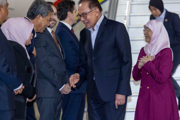 Malaysian Prime Minister Anwar Ibrahim is greeted by officials as he arrives in Melbourne for the ASEAN Summit.
