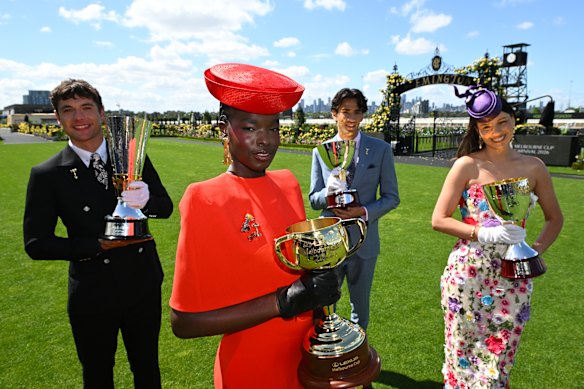 Achan Meshwang with the 2026  Melbourne Cup trophy as the Derby, Oaks and Champions trophies are also paraded at Flemington. 