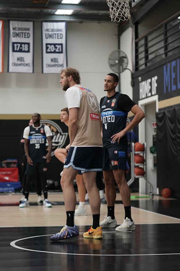 NBA centre Jock Landale (gold jersey) matches up with Melbourne United NBA import Jesse Edwards.
