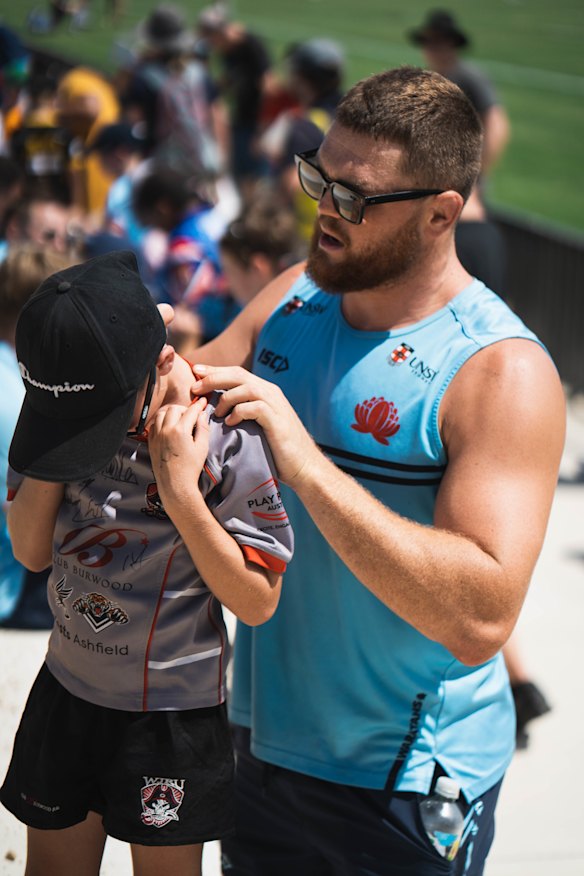 NSW No.6 Lachie Swinton signs autographs at the team’s trial against Shute Shield clubs on the weekend.
