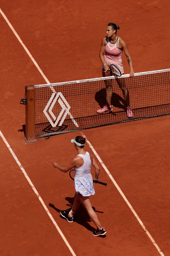 Belarusian Aryna Sabalenka waits at the net as Elina Svitolina of Ukraine refuses to shake hands.