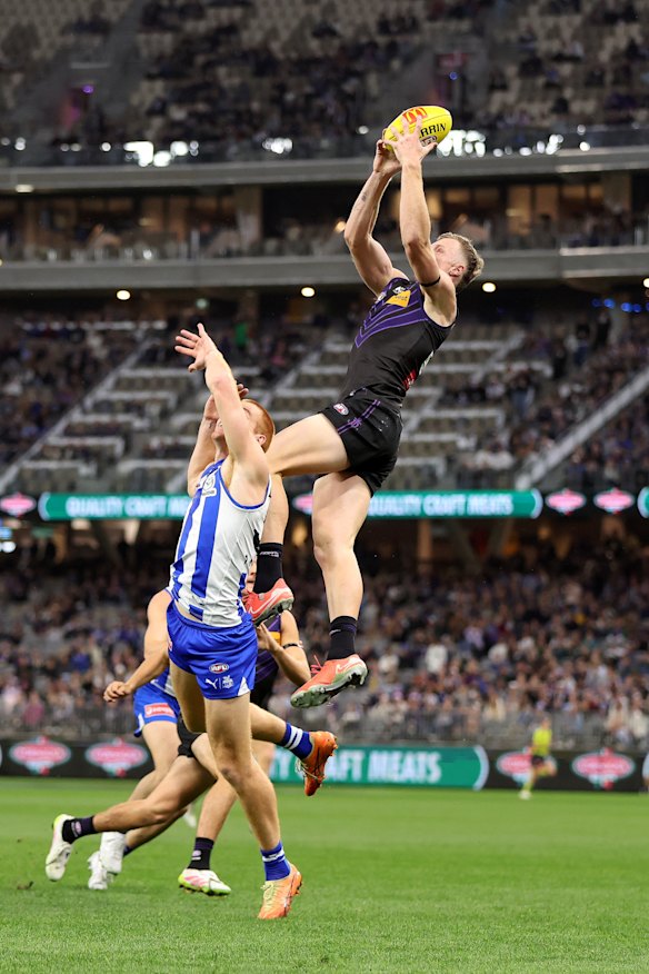 Josh Treacy of the Dockers takes a mark.