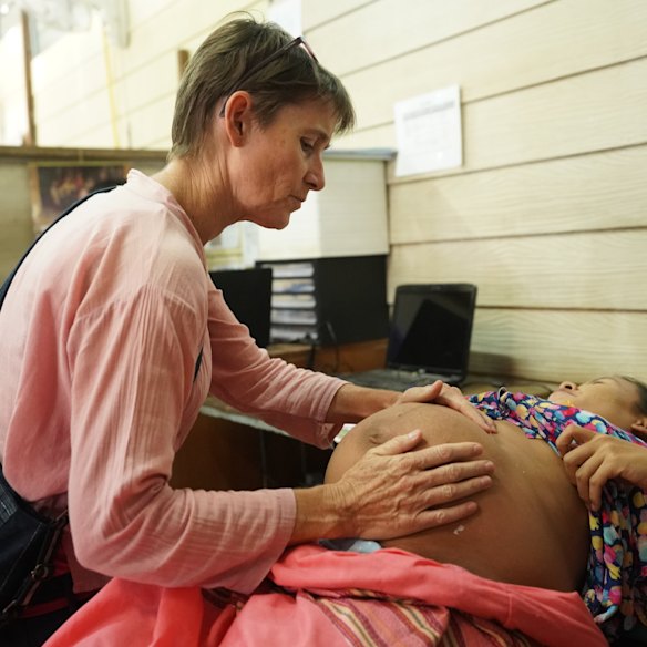 McGready attends to a patient at the Wang Pha clinic.