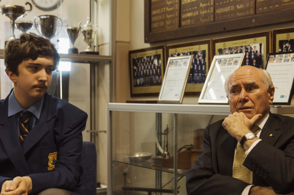 Former prime minister John Howard chats with present-day  Canterbury Boys student, Alexander Lorenzon, during a visit to his old school.