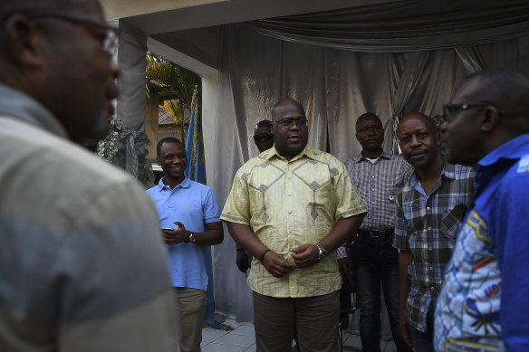 Leader of the Union for Democracy and Social Progress Party and Presidential candidate Felix Tshisekedi (centre) greets staff and supporters at his office in the capital, Kinshasa.